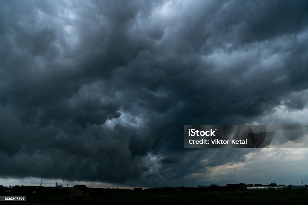 Dramatic stormy sky with thin horizon line. Thunderstorm over the field. Dramatic stormy sky with thin horizon line. Thunderstorm over the field Dramatic Sky Stock Photo