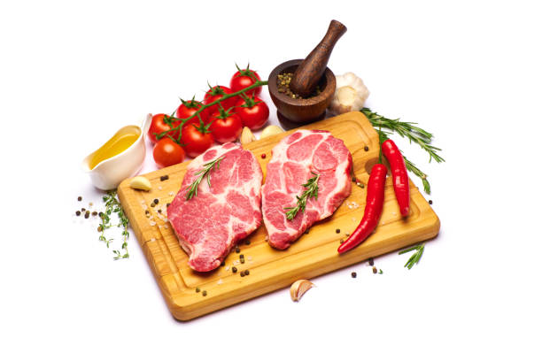 istock Fresh raw beef or pork steaks on wooden cutting board 1330808032