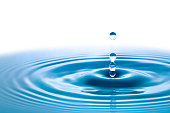 istock Dark blue water droplets splashed closely on the water surface 1330811115