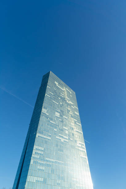 istock Low-angle shot, upper part of a skyscraper in Frankfurt, Germany under blue sky 1330811892