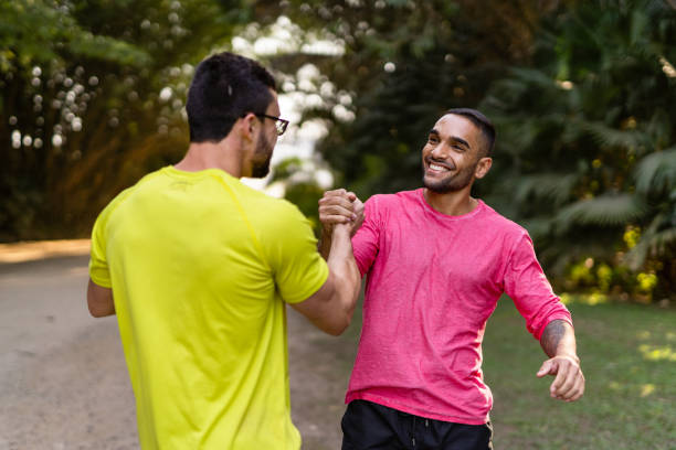 istock Athlete friends greeting each other in the public park 1330812113