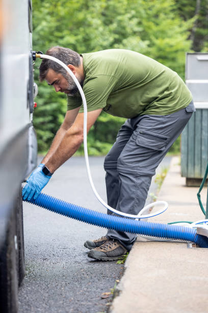 istock Man Emptying RV Sewer at Dump Station After Camping 1330814800
