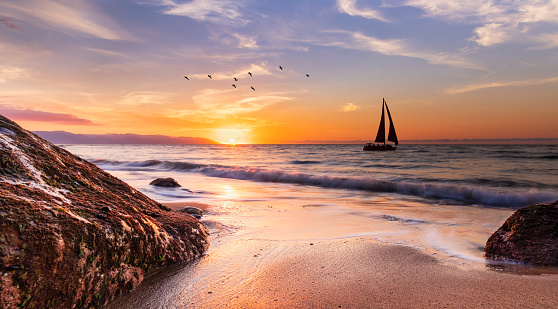 Scenic view of of a fishing boat sailing at sunrise