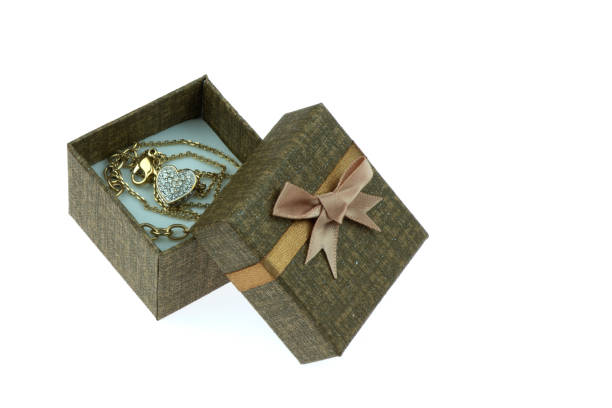 istock Open gift box ,Which has a heart shaped gold necklace inside isolated on the white background. 1330817286