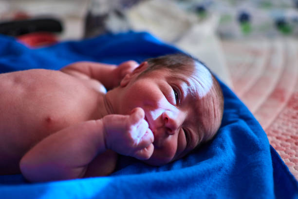 newborn with its umbilical cord