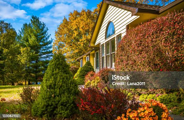 View Of Midwestern House In Late Afternoon In Autumn With Flowers And Bushes In Front Stock Photo - Download Image Now