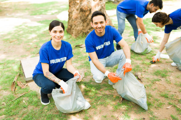 istock Hispanic friends picking up trash outdoors 1330822716