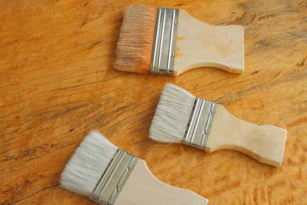 istock paint brush on wooden table background 1330826393