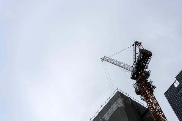 istock Construction Hight rising crane working on construction site build tower with space of blue sky background 1330830203