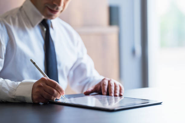istock Man Signing The Digital Contract 1330831944