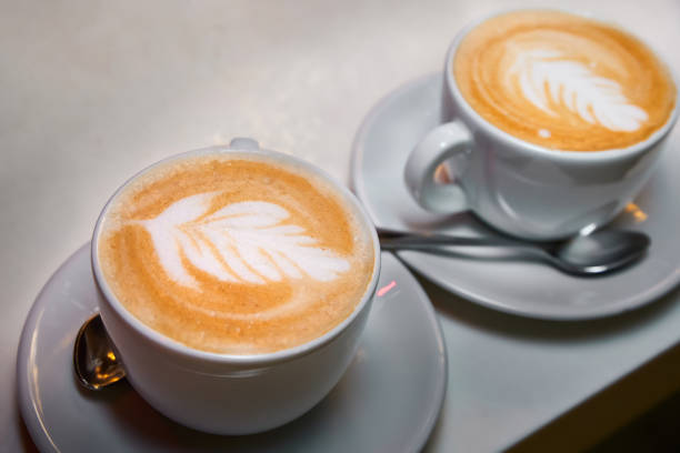 istock Two cups of coffee. Latte with a pattern in white cups. 1330833075