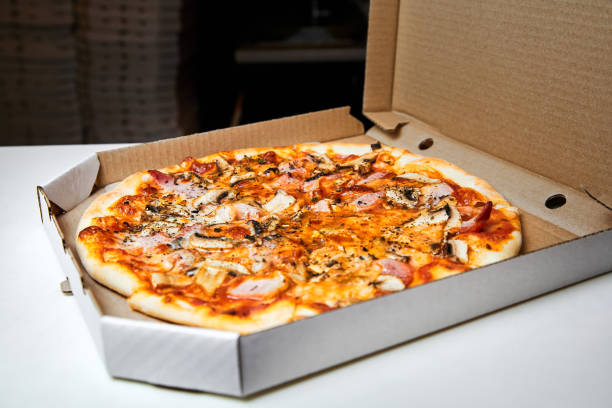 istock Pizza in an open box prepared for delivery 1330833585