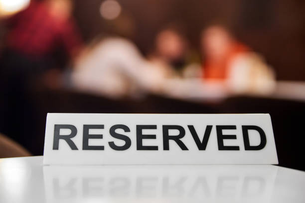 istock Plastic plaque with the inscription Reserved on the restaurant table. 1330833615