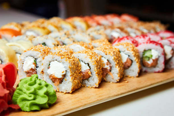 istock Set of various sushi rolls on a board. Close-up, selective focus 1330833622