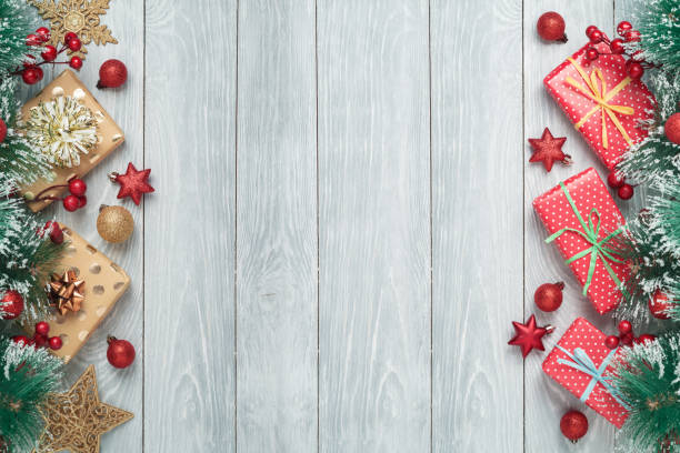 istock Christmas holiday background with gift boxes and decorations on wooden table 1330835528