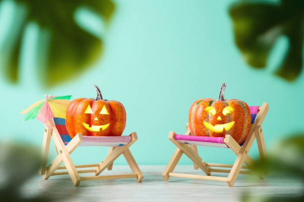 istock Halloween pumpkin jack o lantern with funny face creative concept on tropical beach chair 1330835576