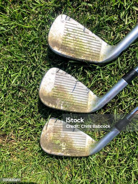 A Closeup View Of Three Golf Irons With Dirty Grooves That Need Cleaning Stock Photo - Download Image Now