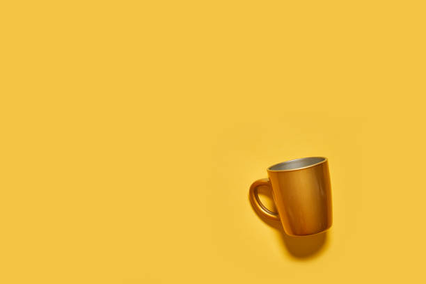 istock Golden drink cup on yellow background 1330838741