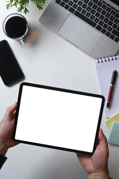 istock Overhead shot man holding digital tablet with white screen. 1330839857