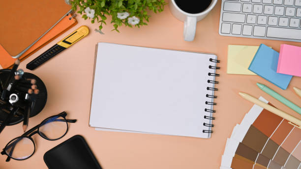 istock Empty notebook, smart phone, color swatch, sticky notes and coffee cup on designer workspace. 1330839891