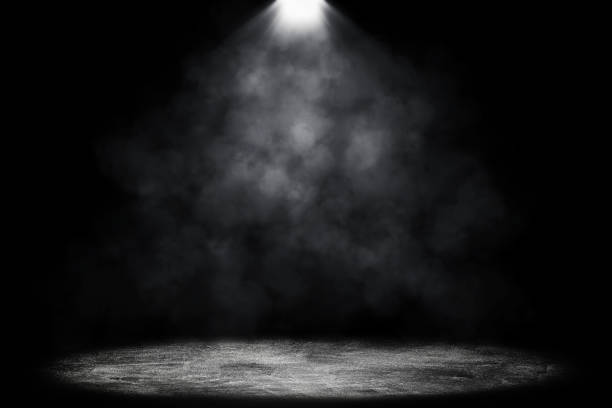 istock Studio dark room concrete floor grunge texture background with spotlight and white smoke. 1330840877