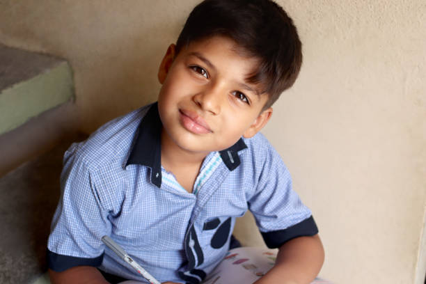 8-9 years schoolboy doing his homework at home.