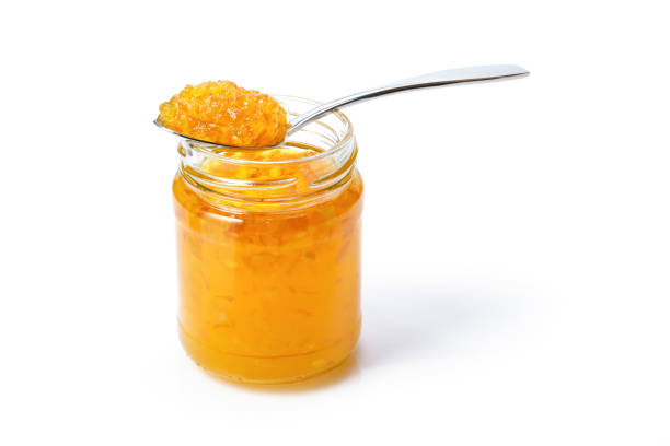 istock Orange Jelly jam in glass jar and spoon 1330842090