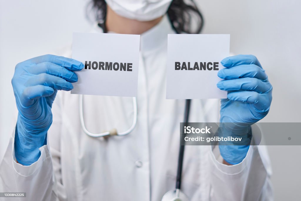 Hormone balance concept A female doctor holding two white cards with Hormone balance words. Hormone balance concept Testosterone Stock Photo