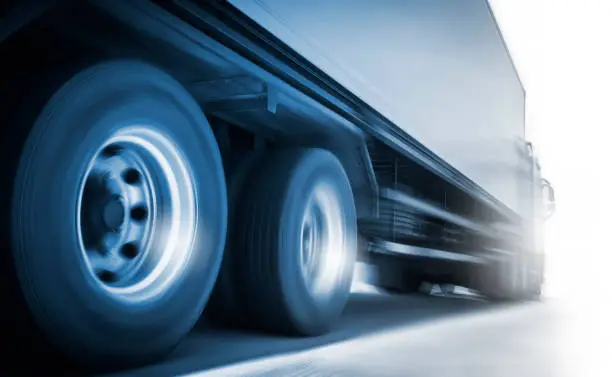 Speed Motion Blur of Semi Truck Driving on The Road. Industry Road Freight by Truck. Logistic and CargoTransport concept.