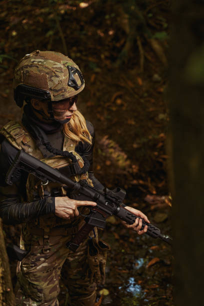 istock Woman standing in forest and holding hand firearms 1330844837
