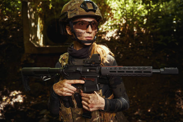 istock Female person in protective glasses holding gun 1330844911