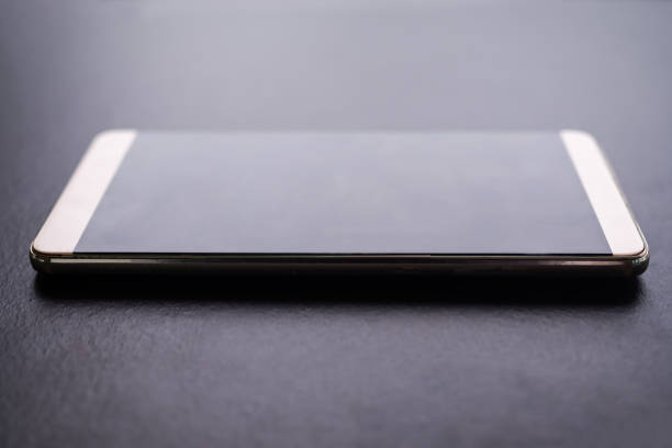 istock Mobile mock up close up on black wooden background. 1330845617
