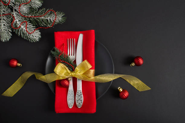 istock Christmas table setting with a red napkin on the black background. Top view. Copy space. 1330846115