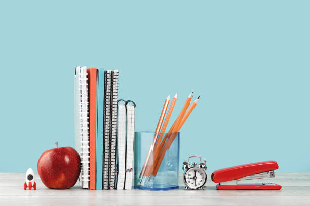 istock Assorted office and school orange and blue stationery with red apple 1330847154