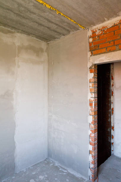 istock Gypsum plaster is applied to a brick wall. Plastered brick wall in the apartment 1330850141