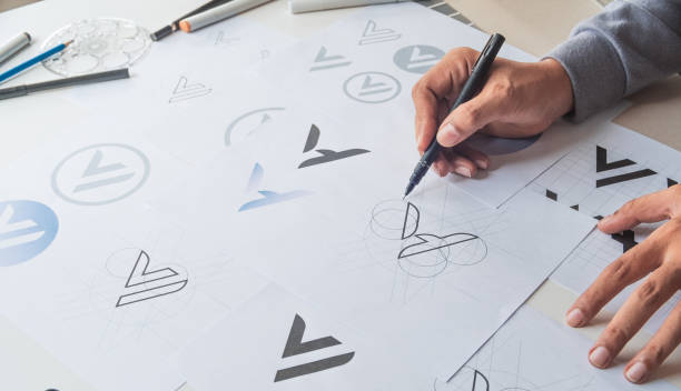 istock Graphic designer drawing sketch design creative Ideas draft Logo product trademark label brand artwork. Graphic designer studio Concept. 1330857648