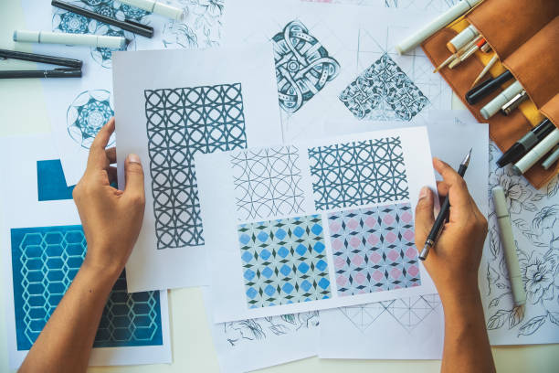 istock Designer designing drawing sketch pattern geometric flower seamless wallpaper fabric textile fashion industry. artistic design studio. 1330857685