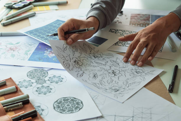 istock Designer designing drawing sketch pattern geometric flower seamless wallpaper fabric textile fashion industry. artistic design studio. 1330857686