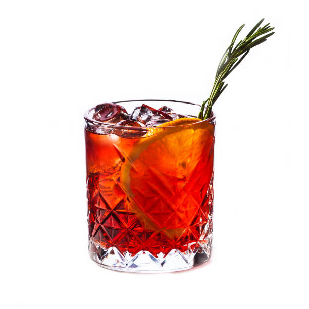 istock Alcohol cocktail with orange and ice isolated on white 1330857955