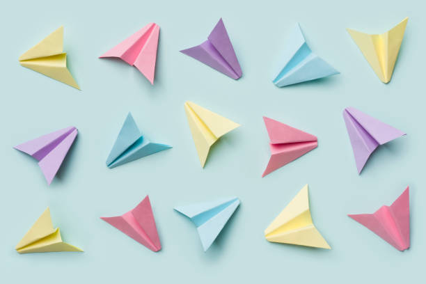istock Handmade multicolor paper origami plane collection isolated on blue background 1330859322