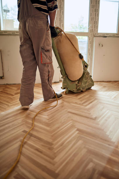 istock Repairman restoring parquet with a sanding machine. 1330860015