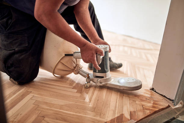 istock Repairman restoring parquet with a sanding machine. 1330860043