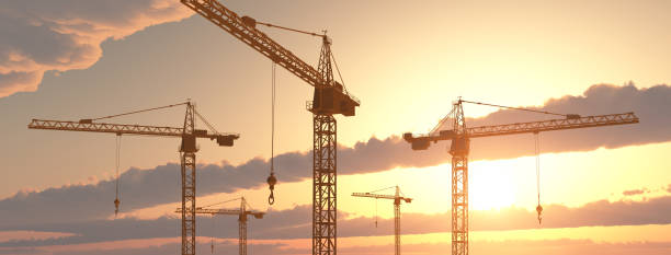 construction cranes at sunset - crane imagens e fotografias de stock