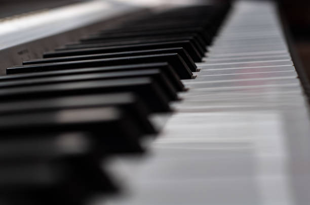 istock Blurred background. Black and white piano keys close up frontal view, classical musical instrument 1330862391