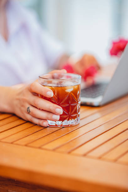 Freelance Woman Drinking Cold Drink From Her Home Balcony