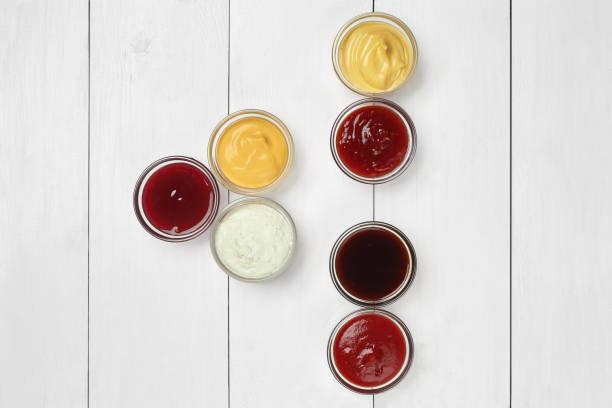 istock Various sauces in glass dipping dishes on white wooden table 1330863174