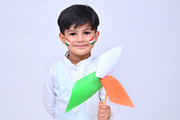 istock Little boy holding tricolor flag studio shot 1330863786
