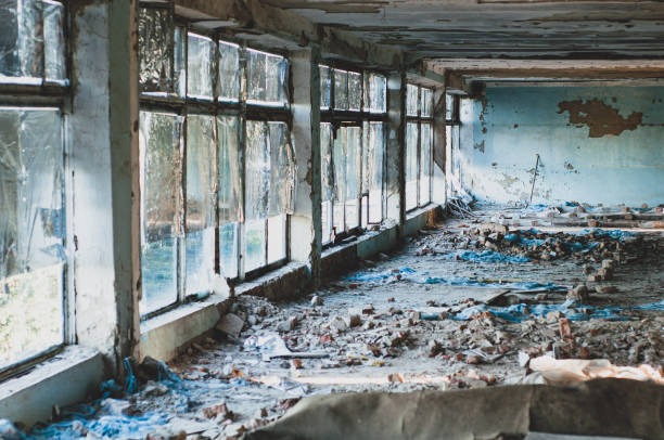 istock Old non-residential building from inside, peeling paint and fallen plaster with various construction debris on floor close-up 1330864170