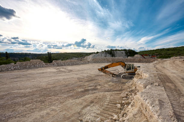 istock Excavator stands on the background of a stone quarry. 1330865003