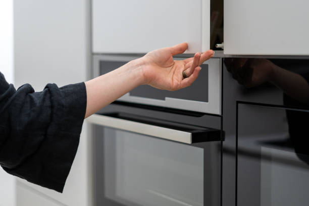 istock Woman holding big white cupboards storage door 1330866671